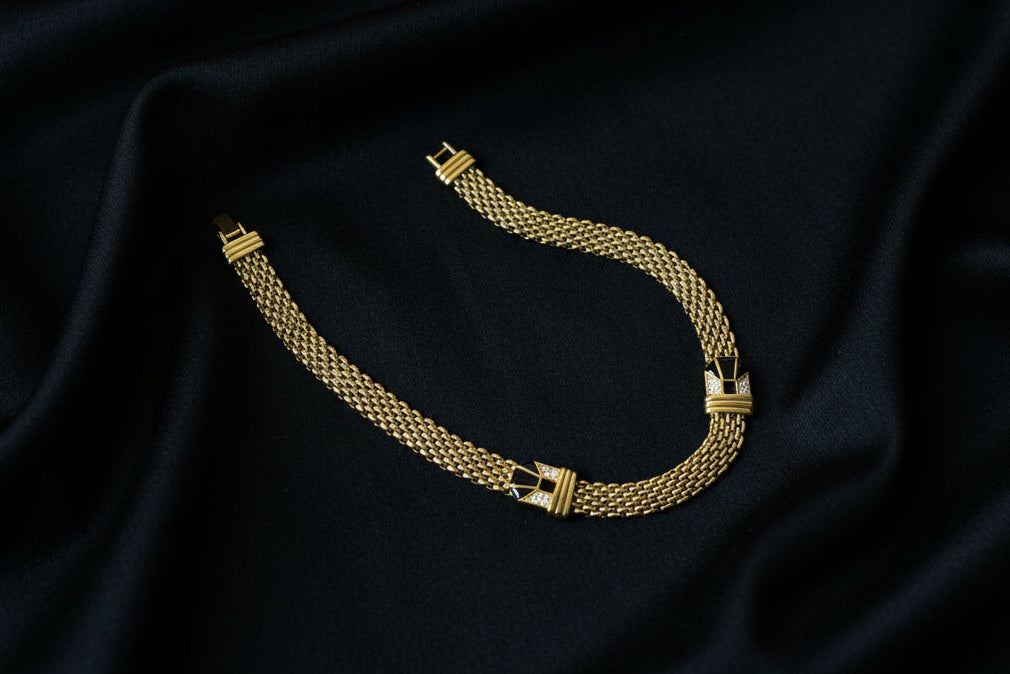 Gold necklace on a black fabric background