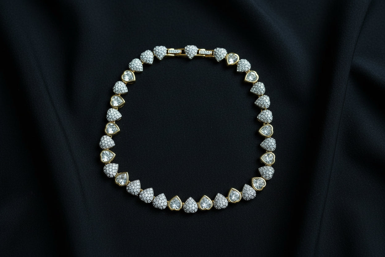 Swarovski Crystal Heart Necklace in Gold Tone on a black fabric background.