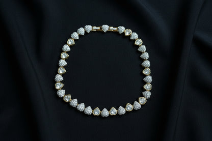 Swarovski Crystal Heart Necklace in Gold Tone on a black fabric background.
