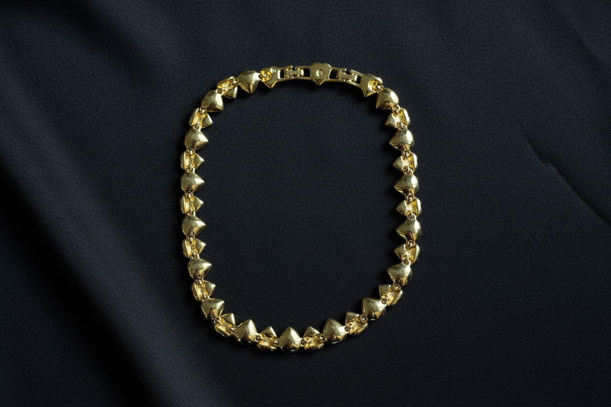 The back of this Swarovski Crystal Heart Necklace in Gold Tone on a black fabric background.