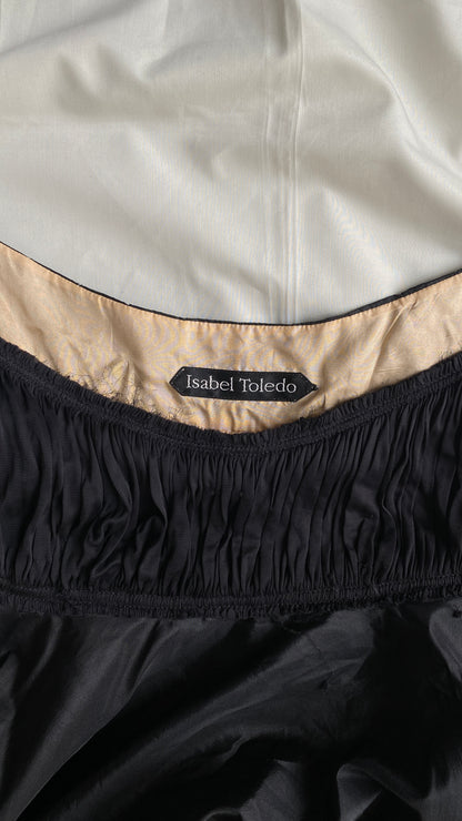Close-up of the Isabel Toledo Sculptural Taffeta Dress neckline, showing the 'Isabel Toledo' label, beige interior lining, displayed on a white fabric background.