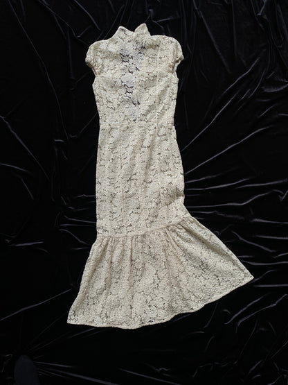 Victoria Beckham Lace Midi Dress in Ivory on a black fabric background.