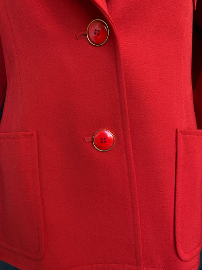 Close-up of the front two buttons fastened, on the vibrant red Yves Saint Laurent Rive Gauche Variation Jacket.