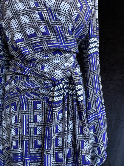 Amanda Wakeley Silk Wrap Dress geometric print in shades of blue. The middle section is shown, with a belt wrapped around the waist, in the same material.