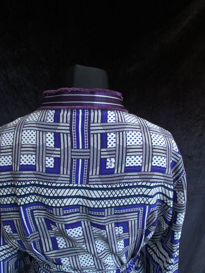 The back of the top half of Amanda Wakeley Silk Wrap Dress, geometric print in shades of blue.