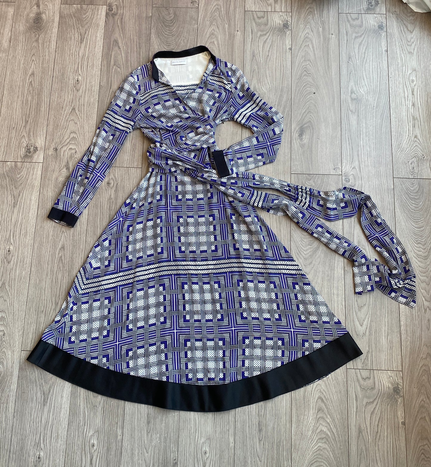 Amanda Wakeley Silk Wrap Dress geometric print in shades of blue laid out on a floor.