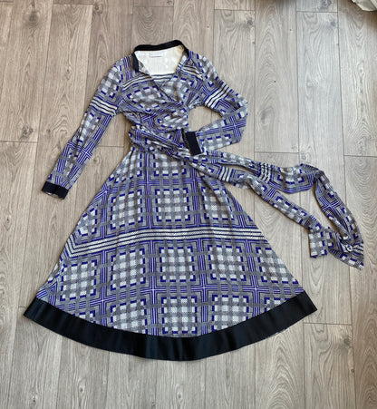 Amanda Wakeley Silk Wrap Dress geometric print in shades of blue laid out on a floor.