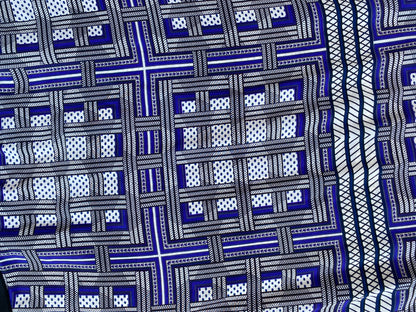 A close up of the geometric print in shades of blue, on the Amanda Wakeley Silk Wrap Dress.