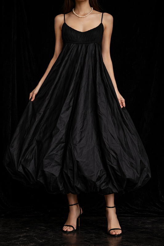 From the neck down, a person modelling the Black Isabel Toledo Sculptural Taffeta Dress. The background is black. 