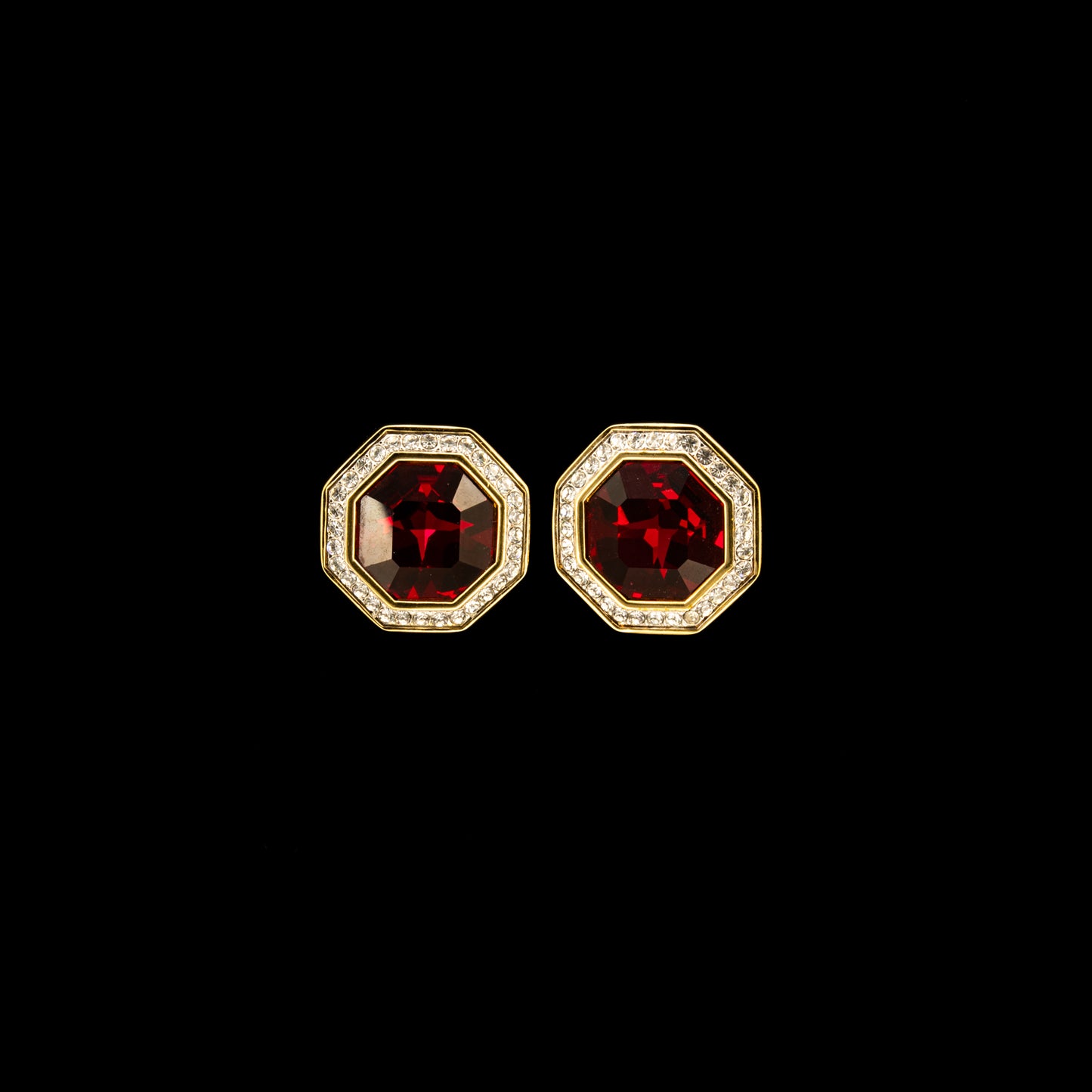 Swarovski Octagonal Earrings, Ruby Red Crystals in the centre with gold accents on a black background.