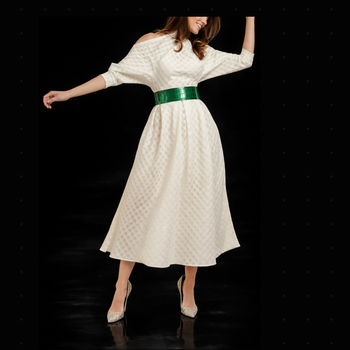 Woman wearing a Ralph & Russo “Snow White” Cut-Out Dress with a green belt on a black background.