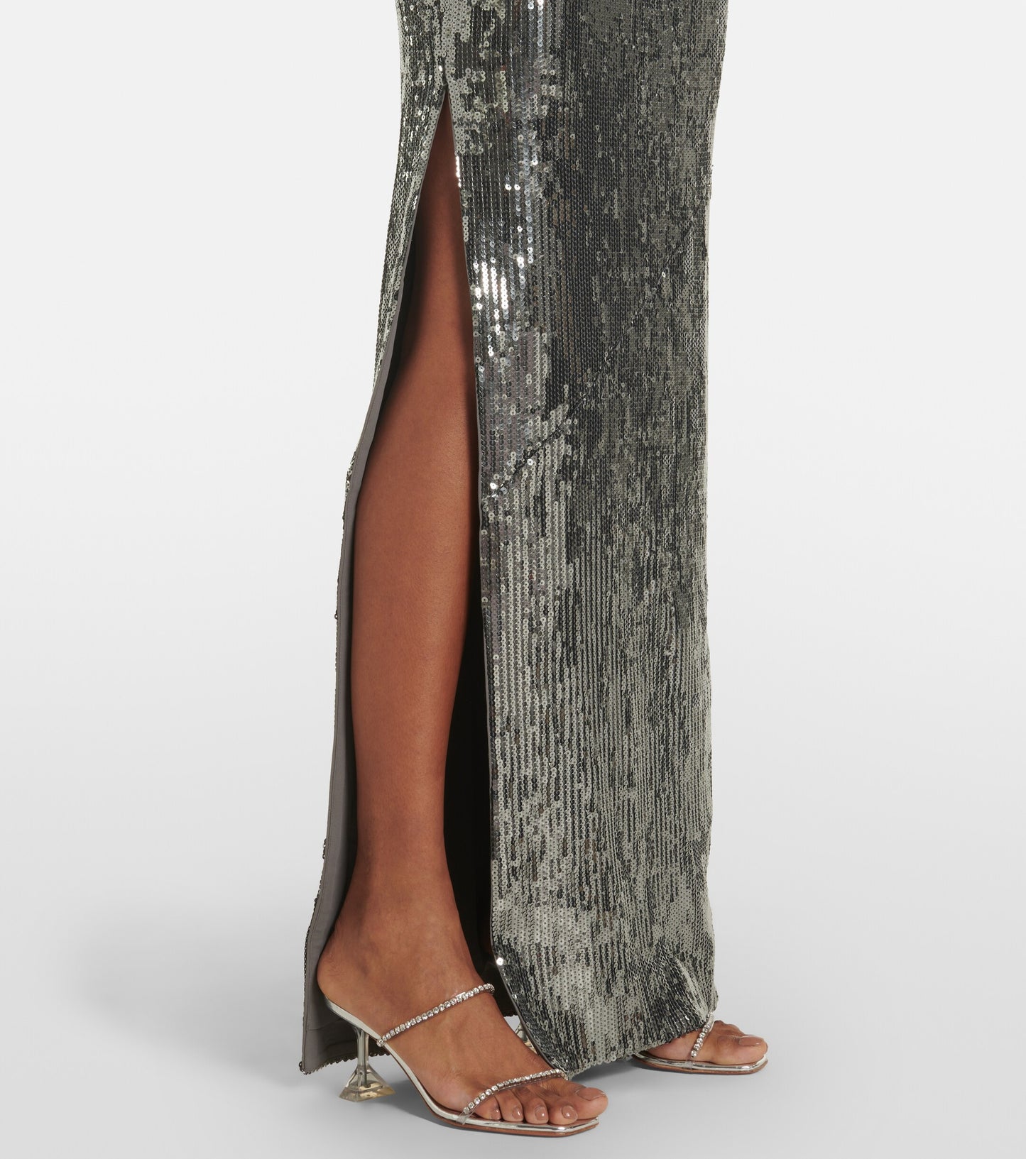 Roland Mouret Asymmetric Sequin Gown Silver with a high slit on a white background.