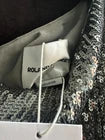 Close-up of the label on the Roland Mouret Asymmetric Sequin Gown.