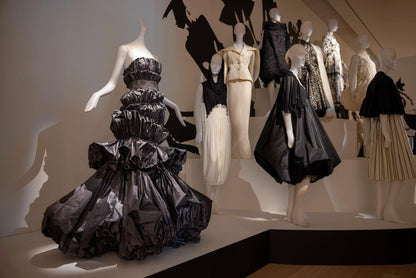 Mannequins wearing various Isabel Toledo outfits in a display setting. One of the outfits includes the Sculptural Taffeta Dress.