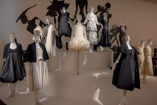 Mannequins wearing various Isabel Toledo outfits in a display setting. One of the outfits includes the Sculptural Taffeta Dress.